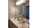 Bright bathroom featuring double sinks with modern chrome faucets, and a large mirror at 2049 Winding Oak Rd, Rock Hill, SC 29732