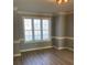 Bright dining area featuring elegant crown molding, stylish trim work, and a large window with blinds at 2049 Winding Oak Rd, Rock Hill, SC 29732