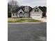 Charming home features a well-manicured lawn, attached two car garage, and a covered front entryway at 2049 Winding Oak Rd, Rock Hill, SC 29732