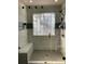 Newly remodeled tile shower with glass door, seat, and rainfall shower head is luxurious and inviting at 2049 Winding Oak Rd, Rock Hill, SC 29732