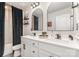 This bathroom features a double vanity, sleek fixtures, and modern decor at 2130 Blewett Dr, Charlotte, NC 28269