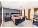 A stylish bedroom features blue accents, statement wall and an eye-catching chandelier at 2130 Blewett Dr, Charlotte, NC 28269