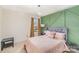 A bright bedroom boasts a window with stylish curtains, and a designer accent wall at 2130 Blewett Dr, Charlotte, NC 28269