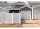 Home exterior with attached garages and a white picket fence to provide privacy at 2130 Blewett Dr, Charlotte, NC 28269