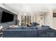 Bright living room with decorative feature wall, luxury vinyl floors and a large sofa at 2130 Blewett Dr, Charlotte, NC 28269