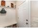 Mudroom with coat hooks, bench, and storage shelves at 2130 Blewett Dr, Charlotte, NC 28269
