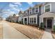 Charming street view featuring townhomes with well maintained lawns, sidewalks, and manicured landscaping at 2130 Blewett Dr, Charlotte, NC 28269