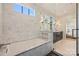 Luxurious bathroom with marble walls, soaking tub, separate glass shower, and double vanity at 238 Laurel S Ave # B, Charlotte, NC 28207