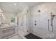 Bathroom with a frameless glass shower and large soaking tub, with a double vanity at 238 Laurel S Ave # B, Charlotte, NC 28207