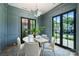 Stylish dining room featuring paneled walls, modern lighting, and doors that lead to a patio at 238 Laurel S Ave # B, Charlotte, NC 28207