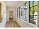 Bright hallway with hardwood floors and large windows that offer views of the outdoors at 238 Laurel S Ave # B, Charlotte, NC 28207