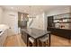 Open kitchen with an expansive island, sleek lighting, stainless steel range hood and hardwood floors at 238 Laurel S Ave # B, Charlotte, NC 28207