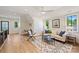Open-concept living area with lots of seating, hardwood floors, and natural light at 238 Laurel S Ave # B, Charlotte, NC 28207