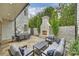 Spacious outdoor patio featuring a stone fireplace, dining area, and comfortable seating with manicured landscaping at 238 Laurel S Ave # B, Charlotte, NC 28207