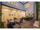 Covered outdoor patio with a fireplace and dining area with comfortable seating, perfect for entertaining at 238 Laurel S Ave # B, Charlotte, NC 28207