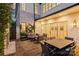 Evening view of a covered patio with a stone fireplace and dining area with comfortable seating at 238 Laurel S Ave # B, Charlotte, NC 28207