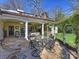 Lovely backyard patio featuring stone flooring, an outdoor dining area, and a view of the manicured lawn at 2423 Lemon Tree Ln, Charlotte, NC 28211