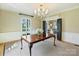 Charming dining room with large table, chandelier, and French doors to the exterior at 2423 Lemon Tree Ln, Charlotte, NC 28211