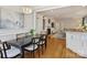 Stylish dining room with hardwood floors, a modern chandelier, and an adjacent living area at 2423 Lemon Tree Ln, Charlotte, NC 28211