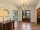 Gracious foyer featuring hardwood floors, a stylish chandelier, and a view of the front yard at 2423 Lemon Tree Ln, Charlotte, NC 28211