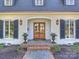 Elegant entryway showcasing a wooden double door, brick steps, and stylish lanterns at 2423 Lemon Tree Ln, Charlotte, NC 28211