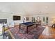 Recreational space featuring a pool table, gym equipment, and a television at 2423 Lemon Tree Ln, Charlotte, NC 28211