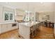 Modern kitchen with large island, stainless appliances, and seamless flow into the dining area at 2423 Lemon Tree Ln, Charlotte, NC 28211