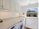 Functional laundry room equipped with modern appliances and ample counter space at 2423 Lemon Tree Ln, Charlotte, NC 28211