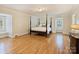 Spacious main bedroom with wood floors and a four-poster bed, and window seat at 2423 Lemon Tree Ln, Charlotte, NC 28211