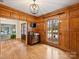 Office space featuring hardwood floors, rich wood paneling, with a light fixture at 2423 Lemon Tree Ln, Charlotte, NC 28211