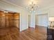 Office space featuring hardwood floors, rich wood paneling, and abundant natural light at 2423 Lemon Tree Ln, Charlotte, NC 28211