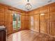 Office space featuring hardwood floors, rich wood paneling, and abundant natural light at 2423 Lemon Tree Ln, Charlotte, NC 28211