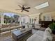 Spacious covered patio with skylight features comfortable seating, a ceiling fan, and seamless outdoor access at 2423 Lemon Tree Ln, Charlotte, NC 28211
