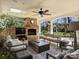 Inviting covered patio boasts a stone fireplace, comfortable seating, and seamless flow to the outdoors at 2423 Lemon Tree Ln, Charlotte, NC 28211