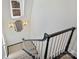 Staircase with dark wood railing and an octagon mirror with wall sconces at 2423 Lemon Tree Ln, Charlotte, NC 28211