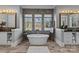 Bright bathroom with a freestanding tub, dual vanities, and natural light at 2615 Farm House Ln, Monroe, NC 28110