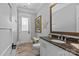 Bathroom featuring granite countertops, a single sink, a wall mirror, and light wood flooring at 2615 Farm House Ln, Monroe, NC 28110