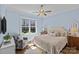 Comfortable bedroom with a large window, soft blue walls, and a plush bed at 2615 Farm House Ln, Monroe, NC 28110