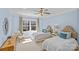 Bedroom with two beds, light blue walls, ceiling fan and natural lighting at 2615 Farm House Ln, Monroe, NC 28110