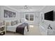 Bedroom featuring a comfy bed, modern art, and window with wooded views at 2615 Farm House Ln, Monroe, NC 28110
