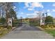 Stone and iron gated entrance to the community with lush landscaping at 2615 Farm House Ln, Monroe, NC 28110
