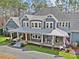 An exterior front elevation view of the house showing a beautiful front porch with columns at 2615 Farm House Ln, Monroe, NC 28110