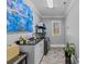 Laundry room featuring a utility sink, washer, dryer, shelving, and decorative artwork at 2615 Farm House Ln, Monroe, NC 28110
