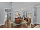 Bright living room with hardwood floors, large windows, a decorative chandelier, and stylish furniture at 2615 Farm House Ln, Monroe, NC 28110