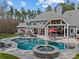 Expansive backyard featuring a large pool, hot tub, covered patio, and outdoor kitchen at 2615 Farm House Ln, Monroe, NC 28110