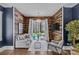 Cozy sitting room with wood paneled walls, large windows, and comfortable seating at 2615 Farm House Ln, Monroe, NC 28110