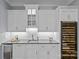 Modern wet bar featuring white cabinetry, granite countertops, and a wine fridge at 2615 Farm House Ln, Monroe, NC 28110