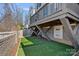Backyard featuring an outdoor deck with artificial grass and brick wall at 2721 Kilgo Way, Charlotte, NC 28205