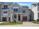 Charming two-story home features a covered front porch, attached garage, and tasteful gray siding at 2721 Kilgo Way, Charlotte, NC 28205
