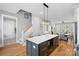 Kitchen island with modern pendant lighting and a view to the staircase and living area at 2721 Kilgo Way, Charlotte, NC 28205